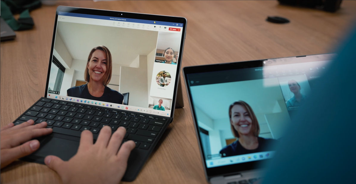 Students participating in a video call lesson using laptops.