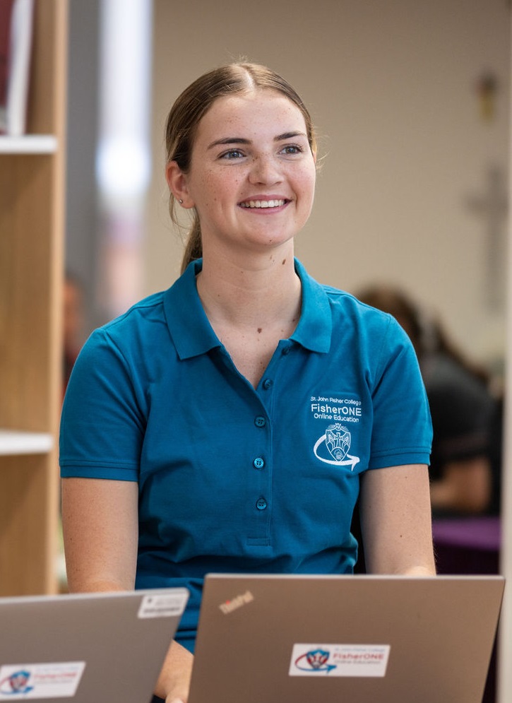 Student using a laptop in a school learning space.
