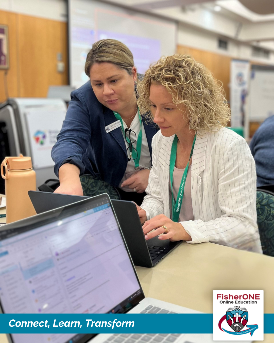 Staff members working together at a laptop during a professional learning session.